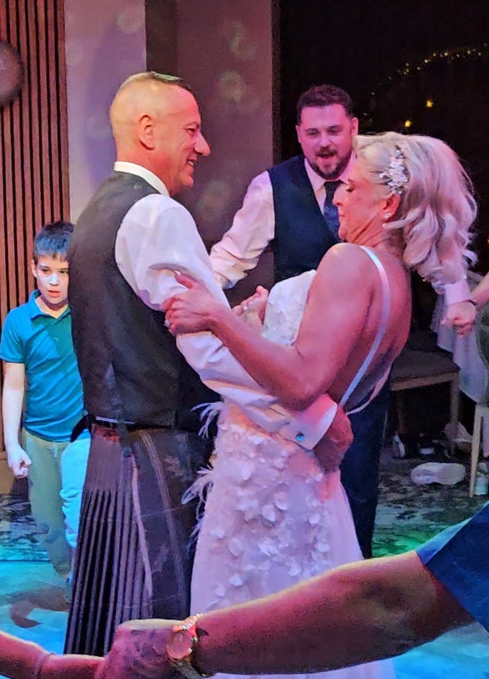 Bride and groom sharing their first dance while guests watch at a Scottish wedding reception